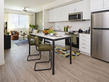 a kitchen and dining room with a table and chairs